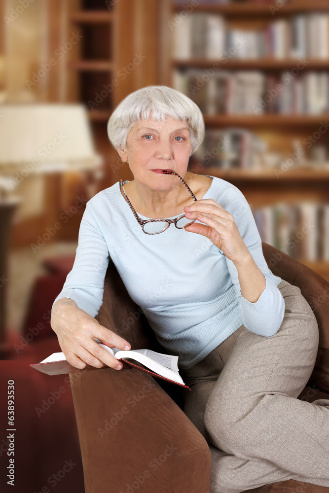 elderly woman with book and glasses sitting in a chair, mother, elderly woman with book and glasses sitting in a chair, mother,