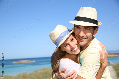 Portrait of sweet couple embracing by the beach