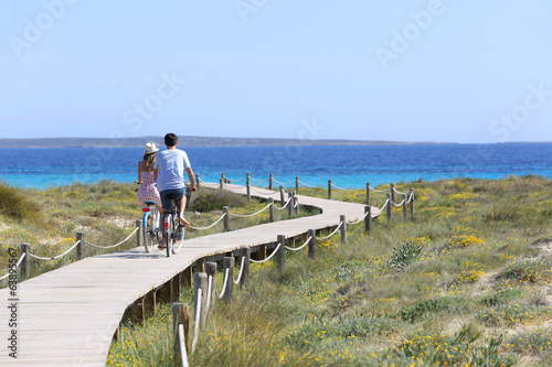 Couple riding bikes on Formentera Island photo