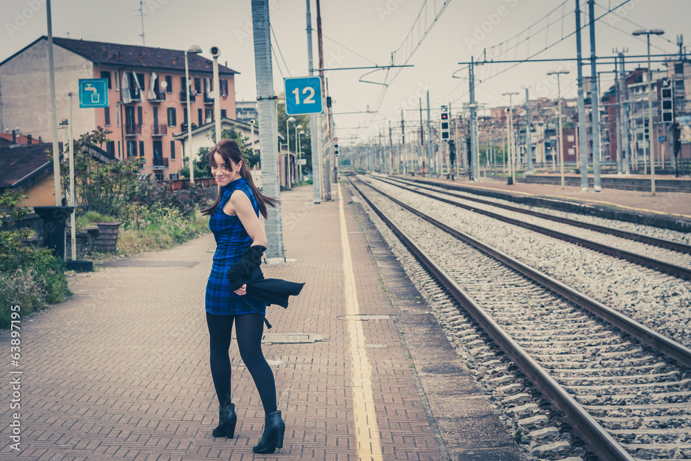Pretty girl posing along the tracks