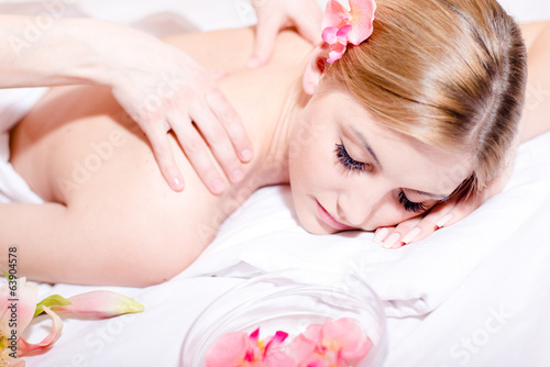 woman having spa treatments: enjoying massage