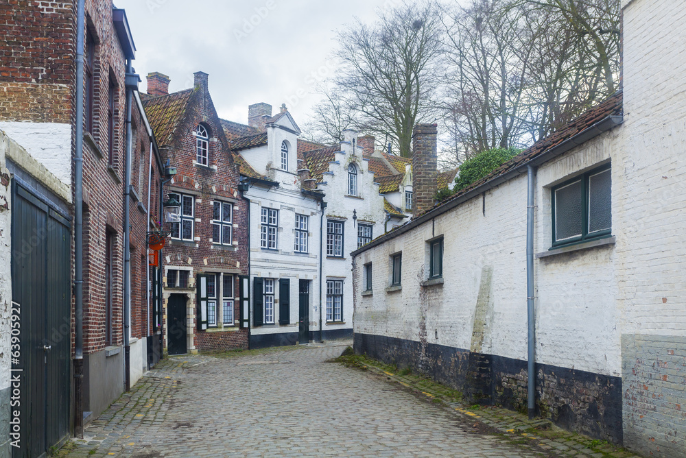 Traditional buildings and cobbled street Bruges, Belgium