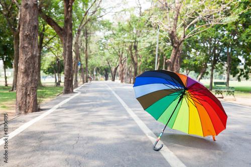 Multicolored umbrella on the sidewalk. © vachiraphan