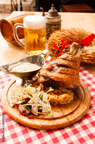Photography eisbein with braised cabbage, salad and beer