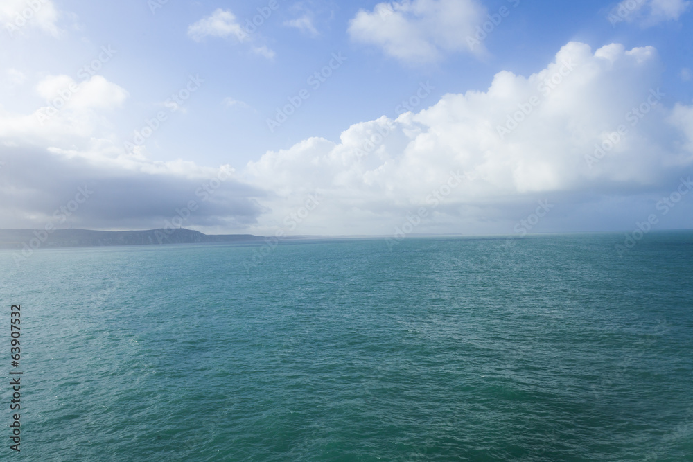 Sea view leaving Dover, with blue sky and clouds