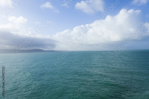 Sea view leaving Dover, with blue sky and clouds