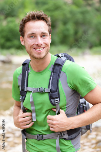 Active man portrait of sporty guy hiking outdoors