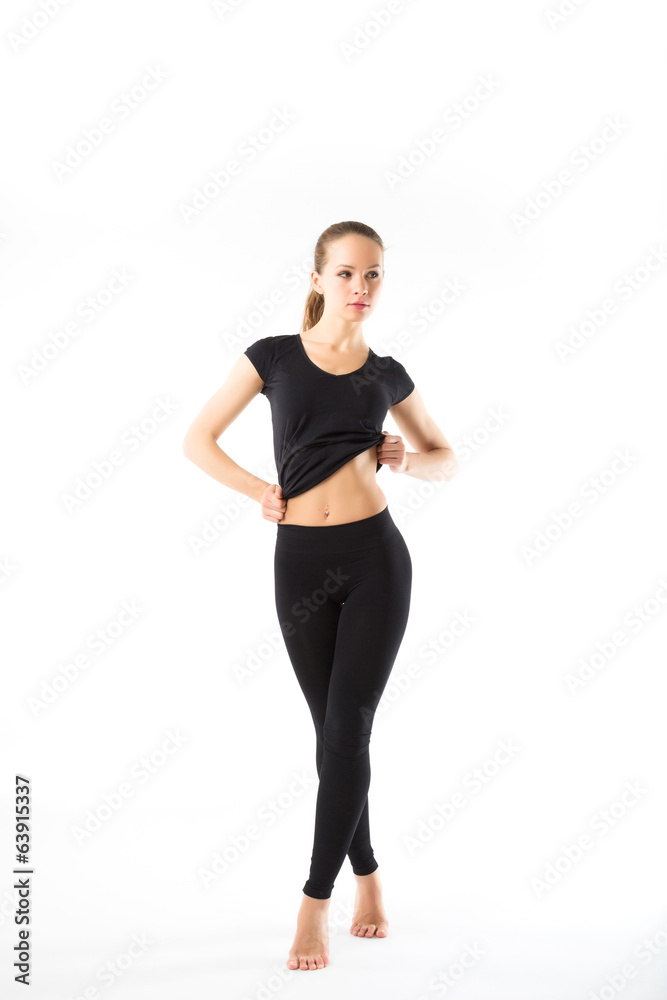 Young sexy athletic woman in black sportswear full-length - isol Young sexy athletic woman in black sportswear full-length - isol