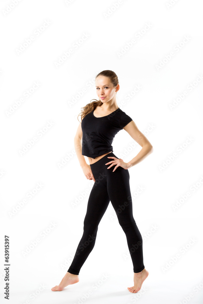 Young sexy athletic woman in black sportswear full-length - isol Young sexy athletic woman in black sportswear full-length - isol