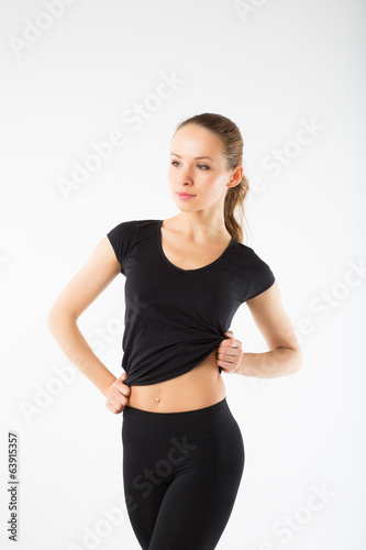 Young sexy athletic woman in black sportswear - isolated on whit