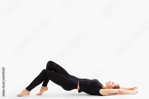 Young sexy sport satisfied woman lying on the floor in black spo
