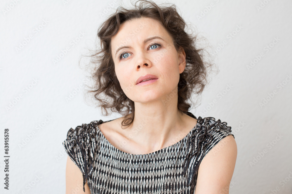 Brown-haired woman thinking about something Brown-haired woman thinking about something