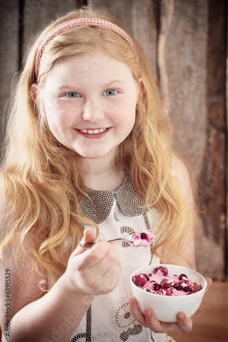 happy girl with dessert on wooden background