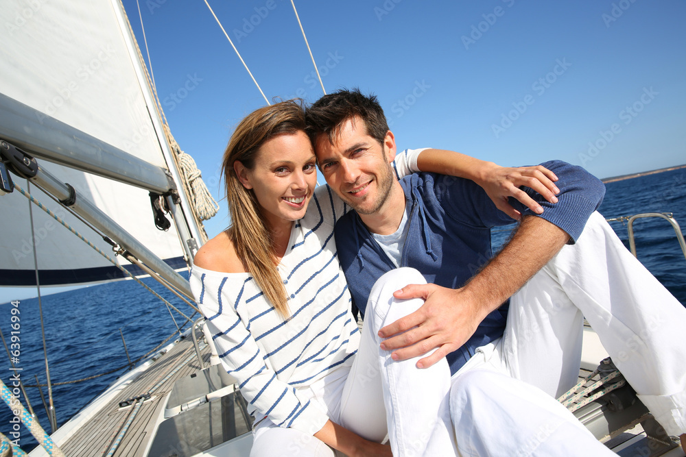 Couple enjoying cruising on sailboat Couple enjoying cruising on sailboat