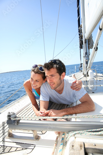 Couple relaxing on sailboat deck © goodluz