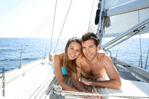 Lucky couple relaxing on sailboat deck