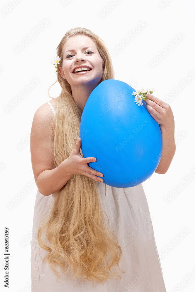 Young Woman with Long Blond Hair and Large Blue Egg. Young Woman with Long Blond Hair and Large Blue Egg.