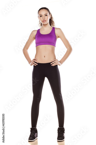 young sporty girl posing on white