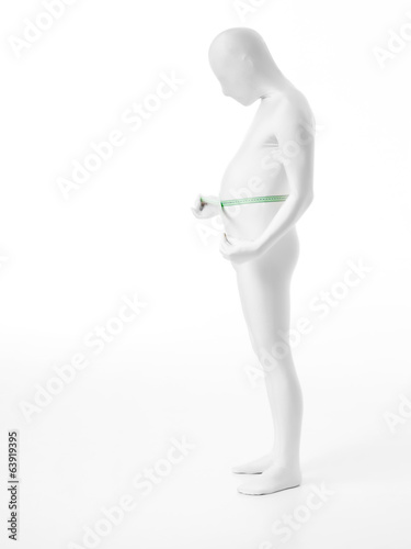 faceless man measures his abdomen