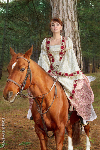 beautiful girl in antique dress on horseback