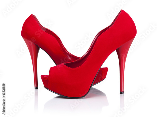 Female red high-heeled shoes over white background.