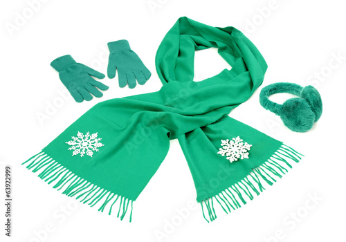 Green wool scarf,gloves and earmuffs on white.Winter accessories