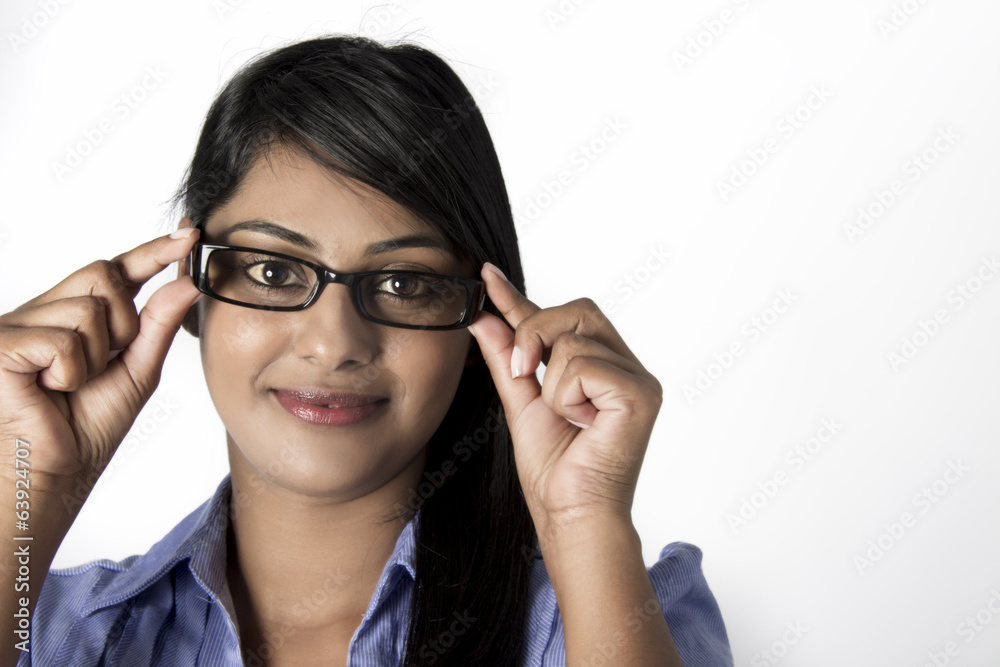 Woman holding her framed glasses with fingers Woman holding her framed glasses with fingers