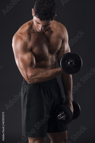 Muscular man lifting weights