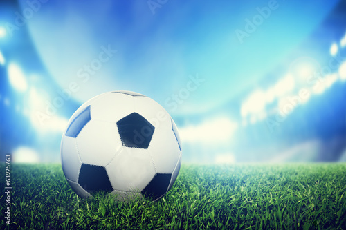 Football, soccer match. A leather ball on grass on the stadium