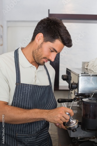 Waiter preparing espresso at coffee shop