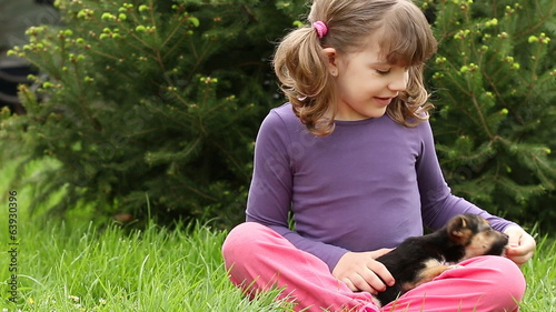 little girl feeding puppy