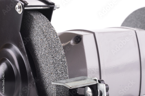 Closeup of bench grinder wheel isolated on white