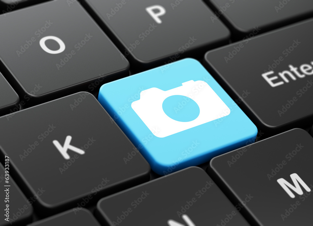 Travel concept: Photo Camera on computer keyboard background Travel concept: Photo Camera on computer keyboard background