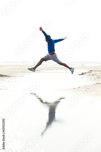 Man running and jumping at the beach