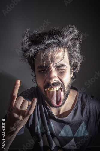 фотографія Rebel young doing the horns hand
