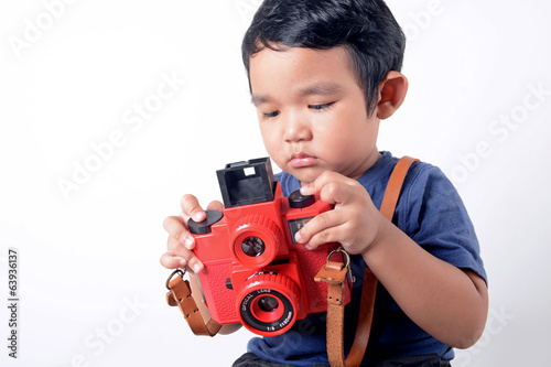 Baby boy holding camera
