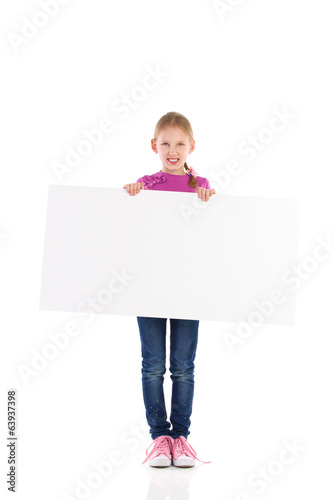 Smilling little girl posing with blank banner.