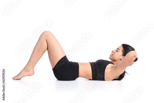 Fitness woman lying doing crunches barefoot