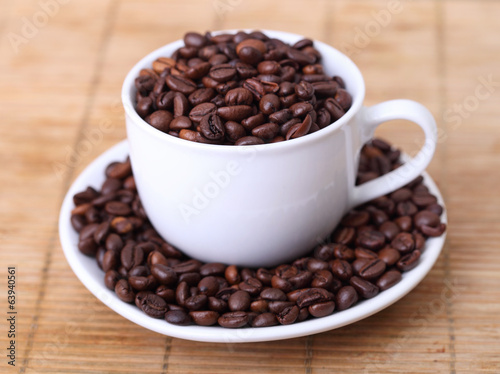 Coffee mug full of coffee beans