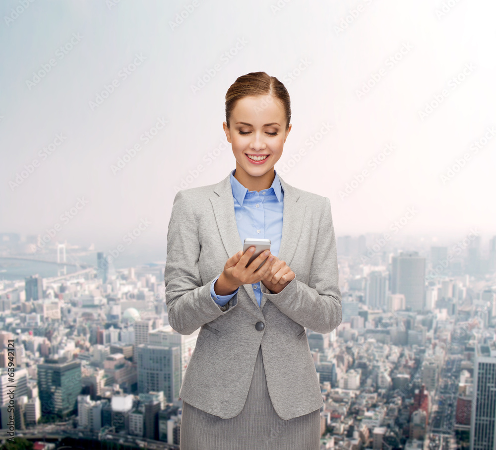 young smiling businesswoman with smartphone