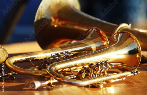 Blowing brass wind instrument on table photo