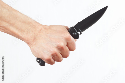 Hand holding a army knife on a white background