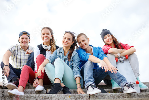 group of smiling teenagers hanging out
