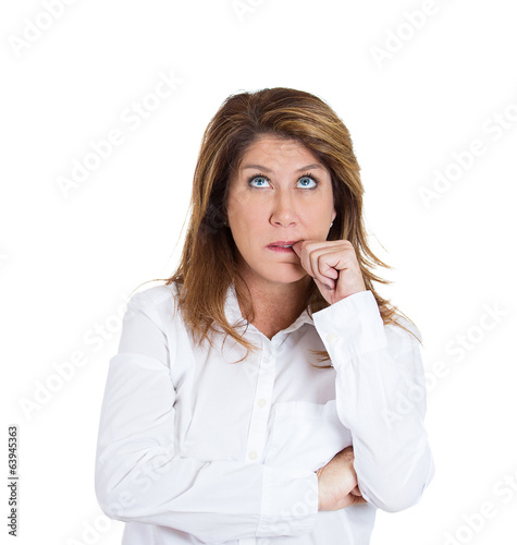 Clueless middle aged woman biting fingernail, sucking thumb