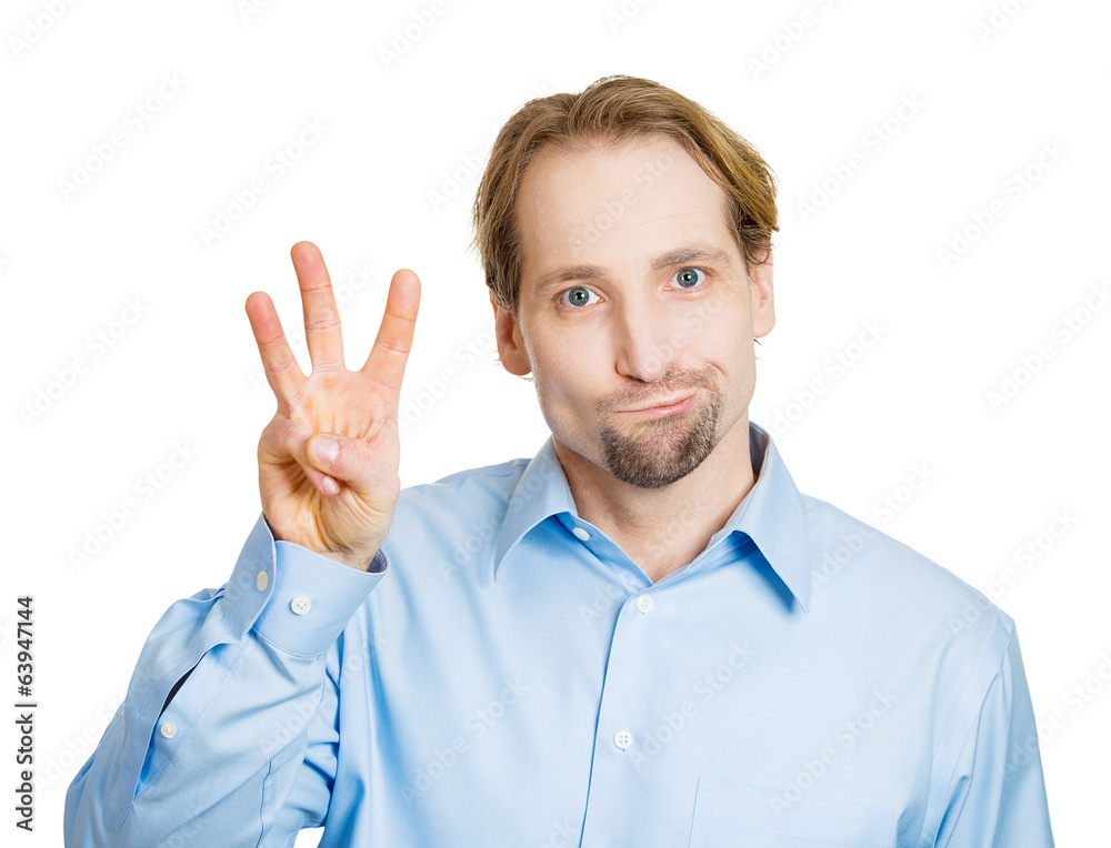 Fototapeta premium Third place. Man shows three fingers, unhappy, white background 