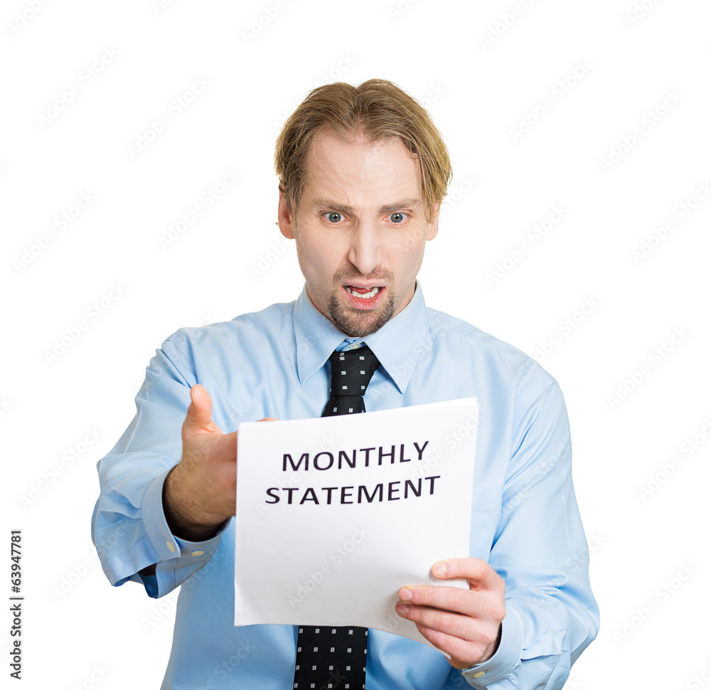 Expensive bills. Man surprised, unhappy about monthly statement Expensive bills. Man surprised, unhappy about monthly statement