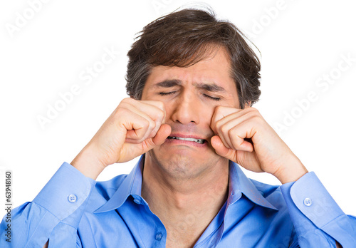 Crybaby, mature man acting out making cry faces, white backgroun