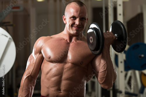 Young Man Doing Exercise For Biceps