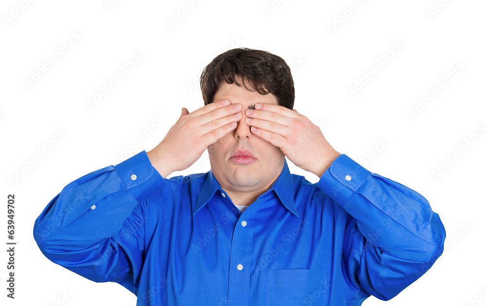 See no evil concept. Young man covering eyes white background See no evil concept. Young man covering eyes white background
