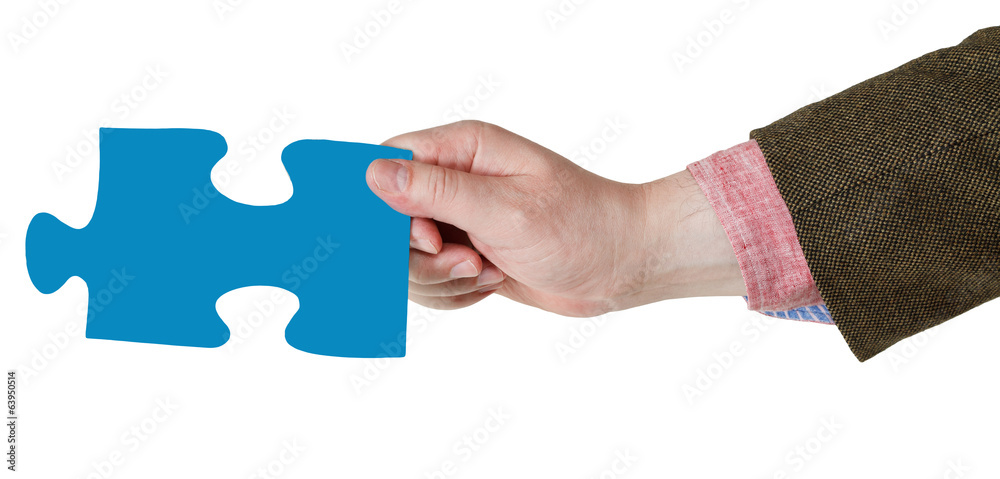 male hand with blue puzzle piece male hand with blue puzzle piece